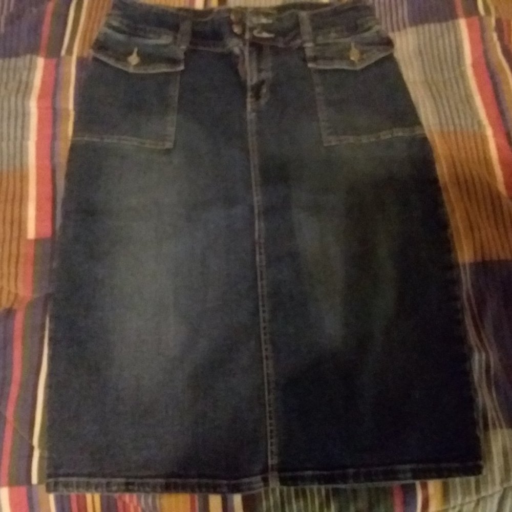 Denim skirt with 2 front button flap pockets and 2 back button flap pockets